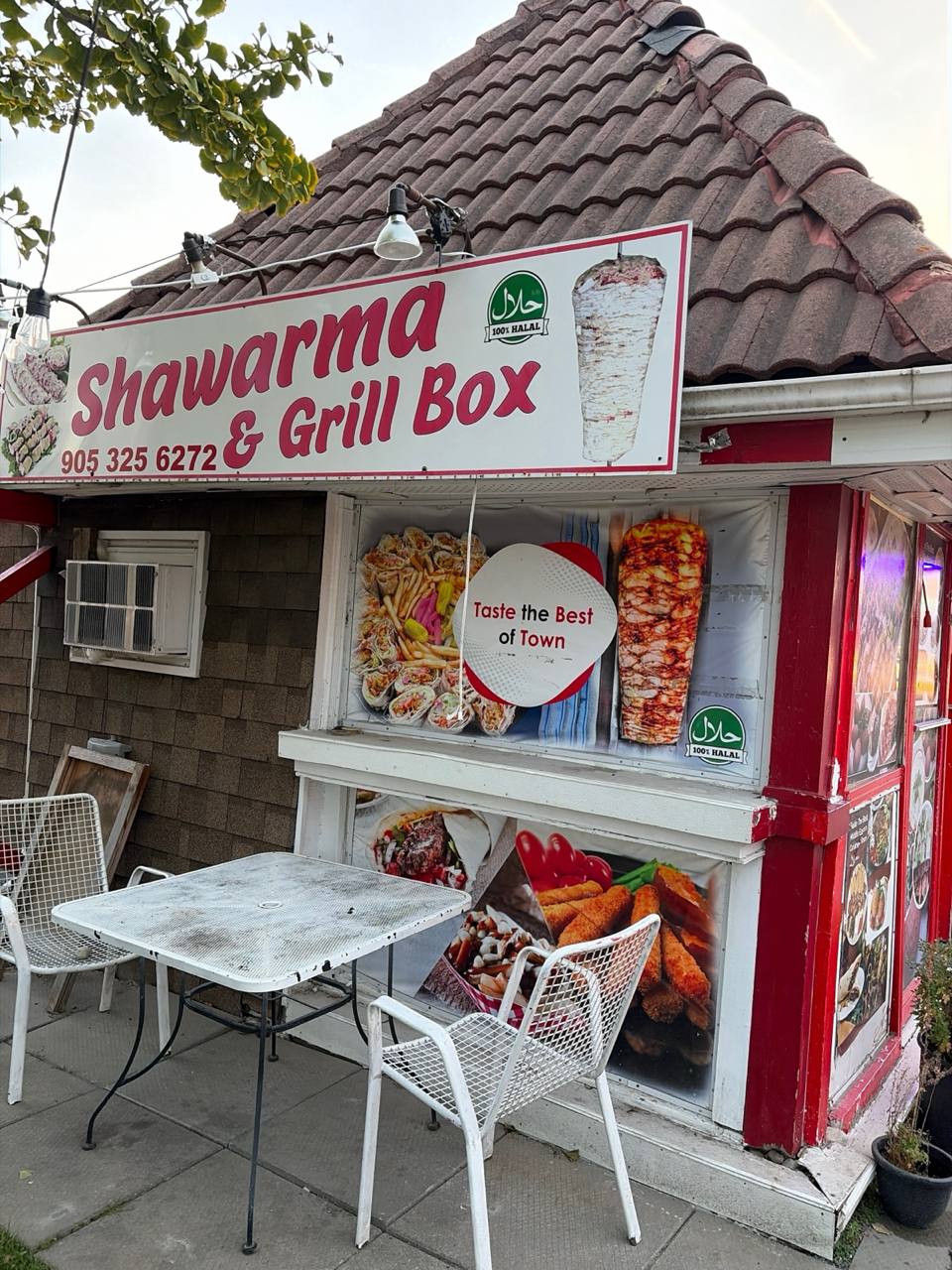 The storefront in daylight, menu posters in the windows